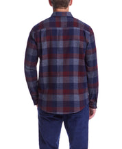 Back view of a man wearing a long sleeve red maroon brushed flannel shirt with a classic plaid pattern.