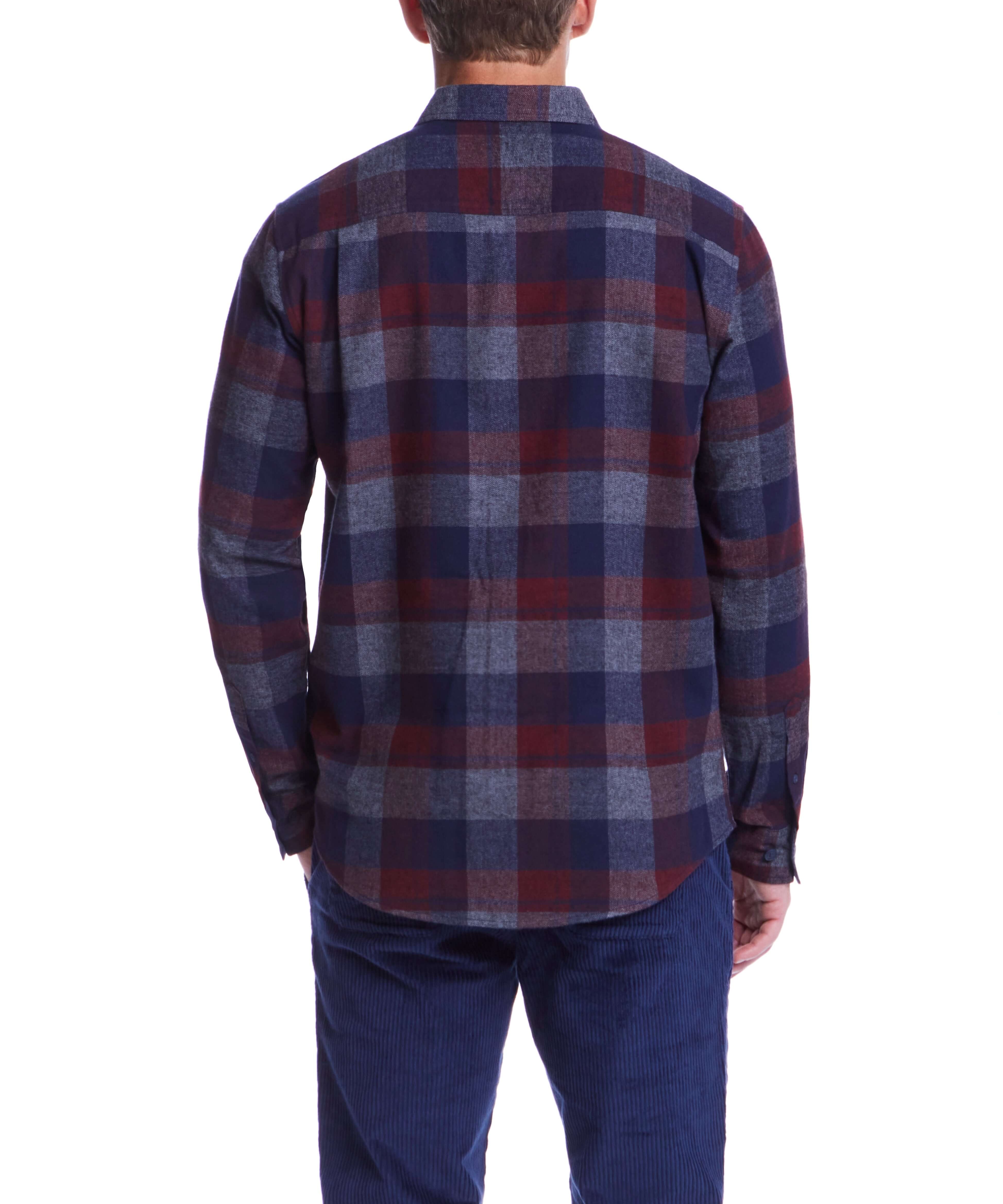 Back view of a man wearing a long sleeve red maroon brushed flannel shirt with a classic plaid pattern.