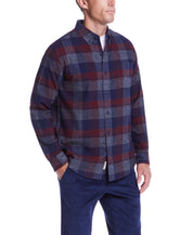 Man wearing a long sleeve red maroon brushed flannel shirt with plaid pattern and button-down collar.