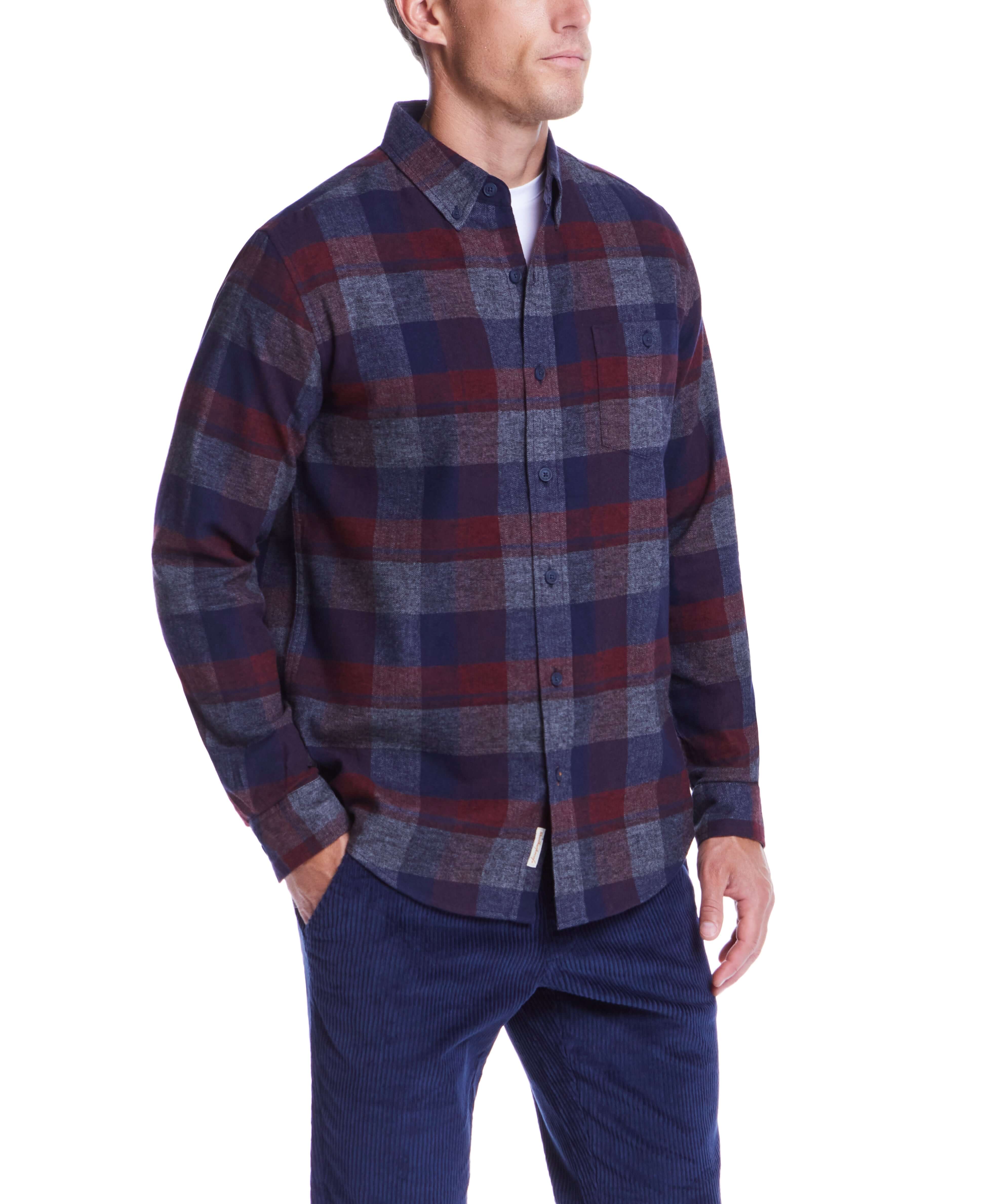 Man wearing a long sleeve red maroon brushed flannel shirt with plaid pattern and button-down collar.