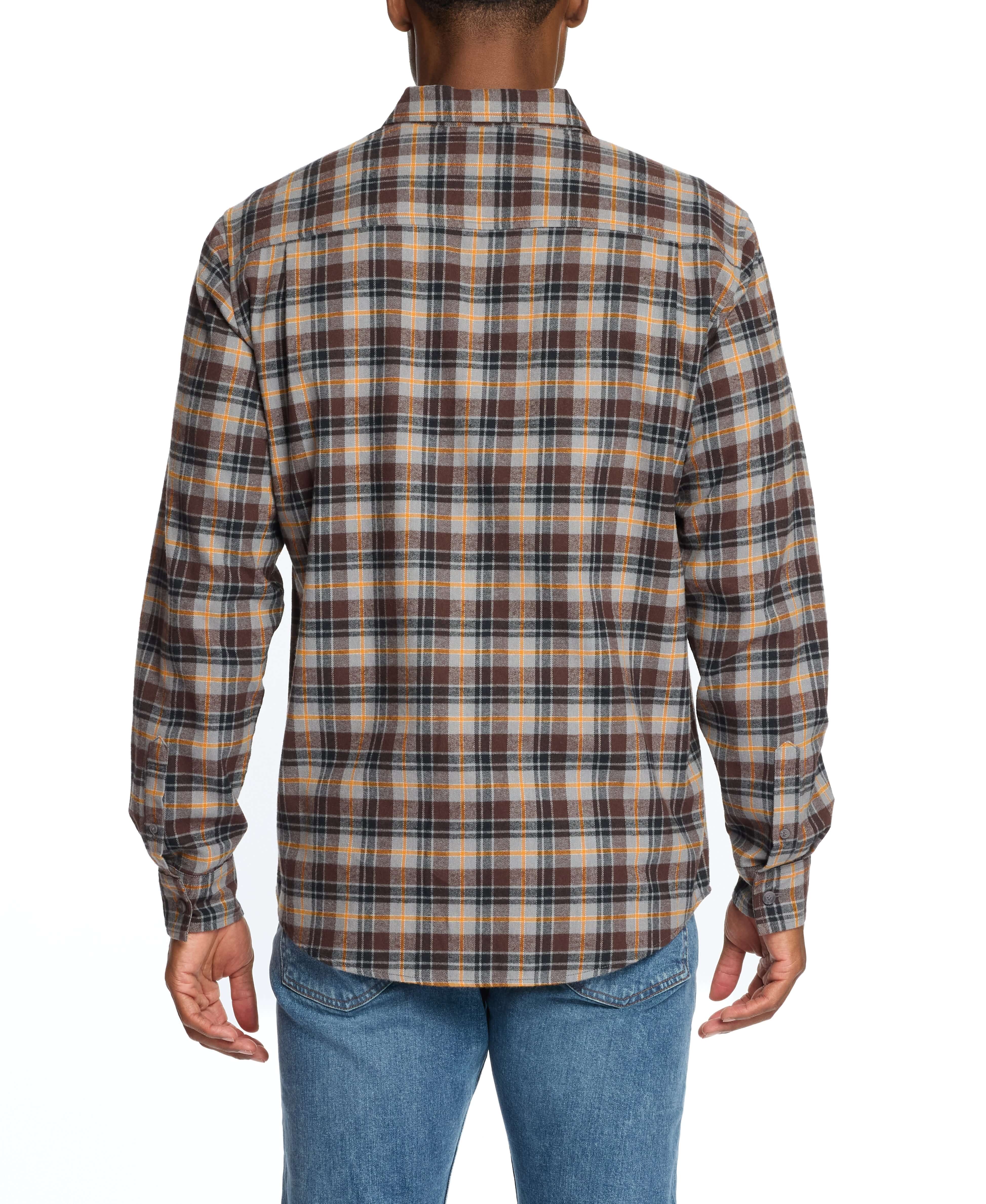 Back view of a man wearing a long sleeve brushed flannel shirt in sharkskin with scaled-up plaid pattern.