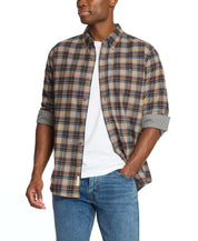 Man wearing a long sleeve brushed flannel shirt in sharkskin with a plaid pattern and rolled sleeves.