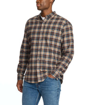 Man wearing a long sleeve brushed flannel shirt in sharkskin plaid, featuring a button-down collar and buttoned breast pocket.