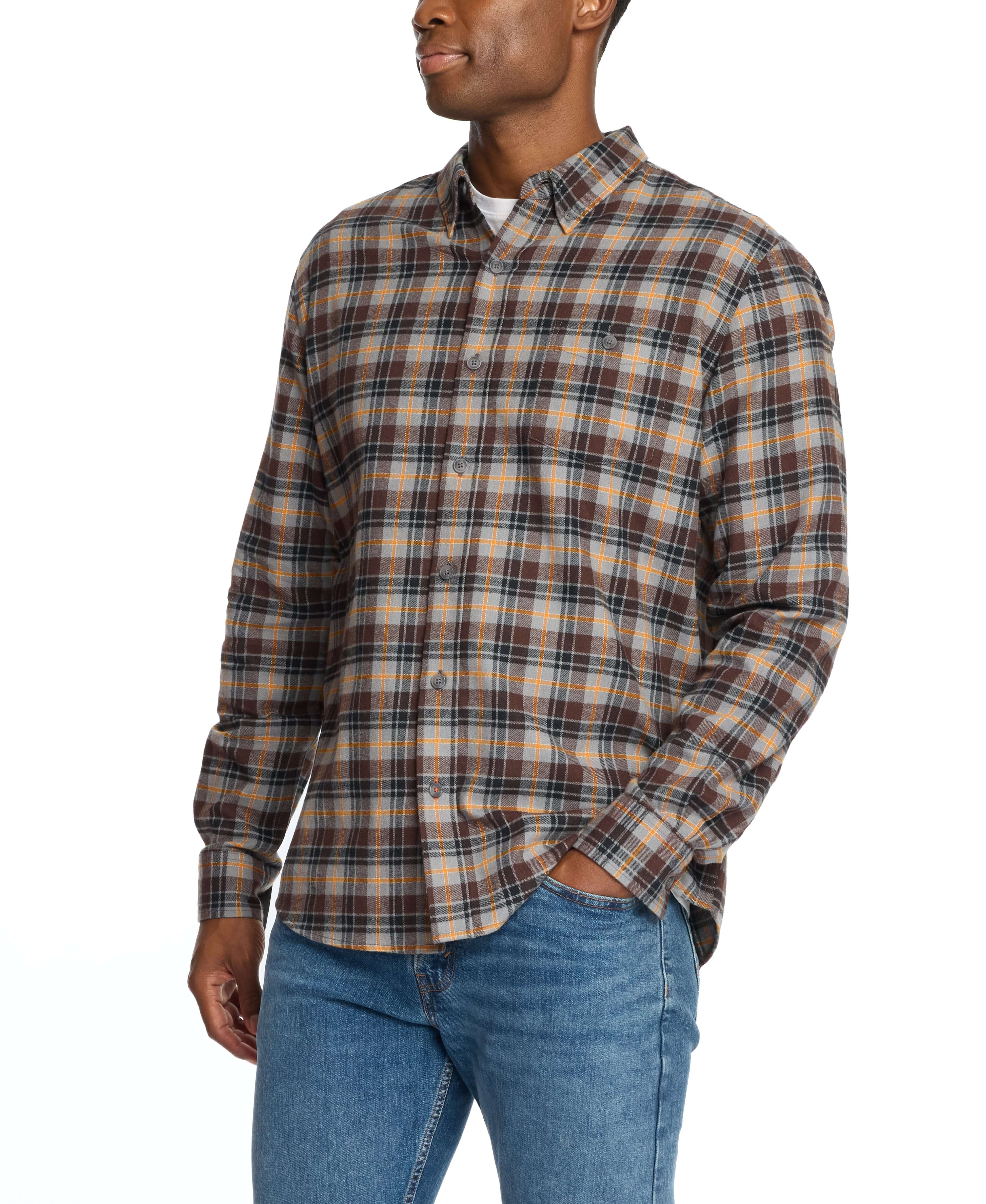 Man wearing a long sleeve brushed flannel shirt in sharkskin plaid, featuring a button-down collar and buttoned breast pocket.