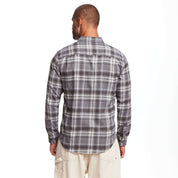 Back view of a man wearing a long sleeve brushed flannel shirt in sleet, featuring a scaled-up plaid design.