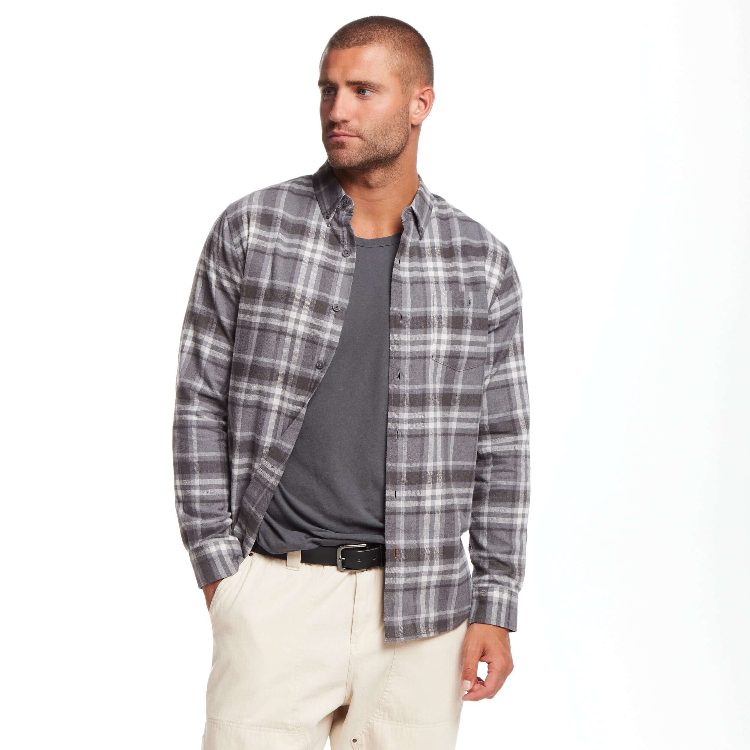 Man wearing a long sleeve brushed flannel shirt in sleet with a button-down collar and buttoned breast pocket.