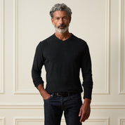 Long Sleeve Brushed V-Neck in Charcoal worn by a man against an elegant backdrop, showcasing its smooth fabric and regular fit.