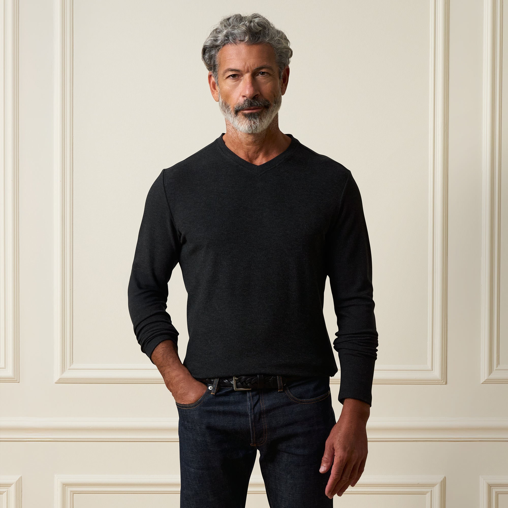 Long Sleeve Brushed V-Neck in Charcoal worn by a man against an elegant backdrop, showcasing its smooth fabric and regular fit.