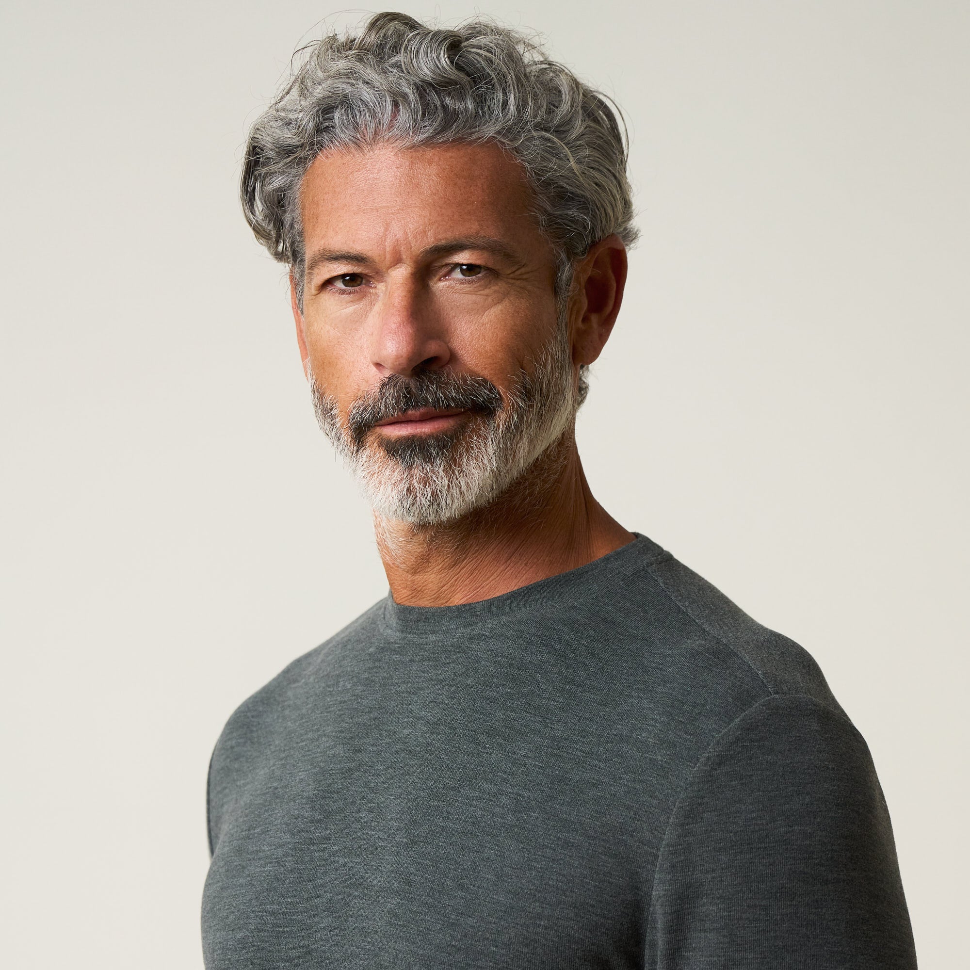 Long Sleeve Crew Neck in Charcoal worn by a man with gray hair, showcasing a soft and stylish look.