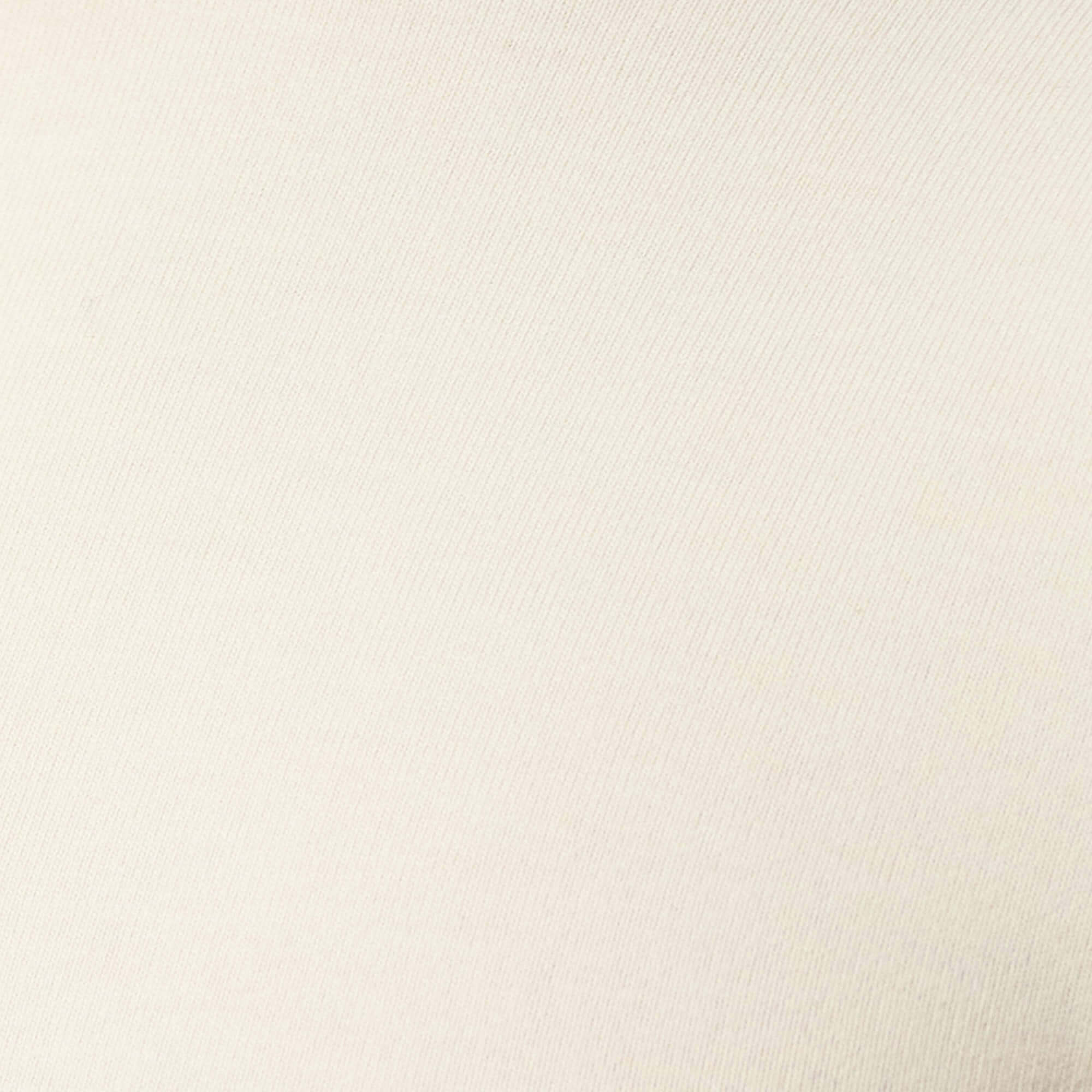 Long Sleeve Crew Neck in Ivory fabric detail, showcasing the soft and smooth texture ideal for layering.