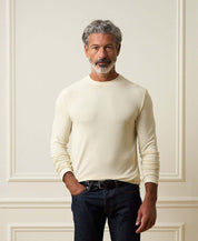 Long Sleeve Crew Neck in Ivory worn by a man against a neutral backdrop, showcasing its soft fabric and relaxed fit.