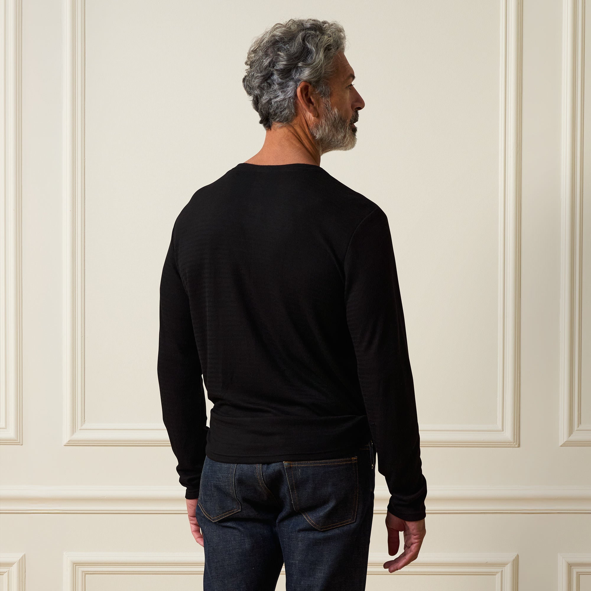 Long Sleeve Crinkle Henley in Black from the back, showcasing a relaxed fit and modern design.