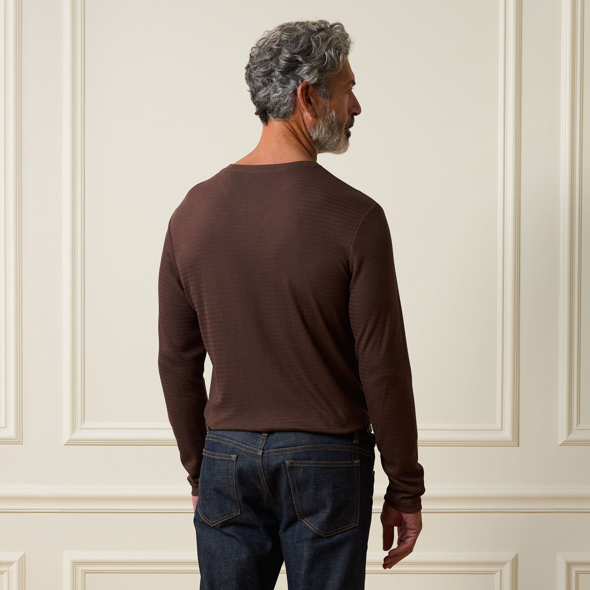 Long Sleeve Crinkle Henley in Brown, showing the back view of a man wearing a stylish crinkled texture long-sleeve shirt.