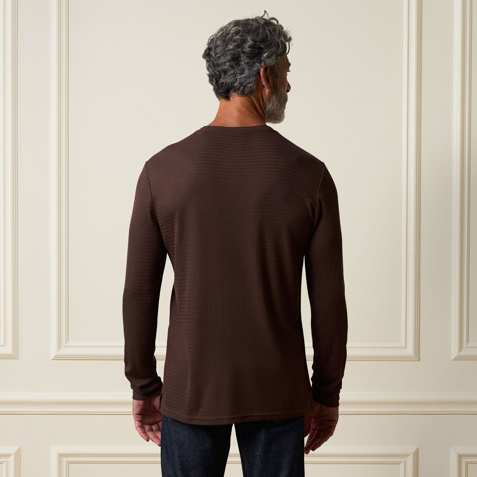 Back view of a man wearing a Long Sleeve Crinkle Henley in Brown against a neutral background.