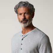 Long Sleeve Crinkle Henley in Grey Heather worn by a man, showcasing its modern and relaxed style with a Henley neckline.