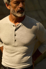 Long Sleeve Crinkle Henley in Grey Heather worn by a man, showcasing its lightweight texture and stylish button placket.