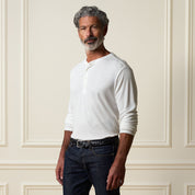 Long Sleeve Crinkle Henley in White worn by a man, featuring a button placket and a relaxed fit.
