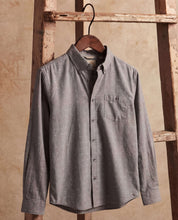 Long Sleeve Dobby Chambray in Moon Mist hanging on a wooden ladder, featuring jacquard dobby texture and button-front.