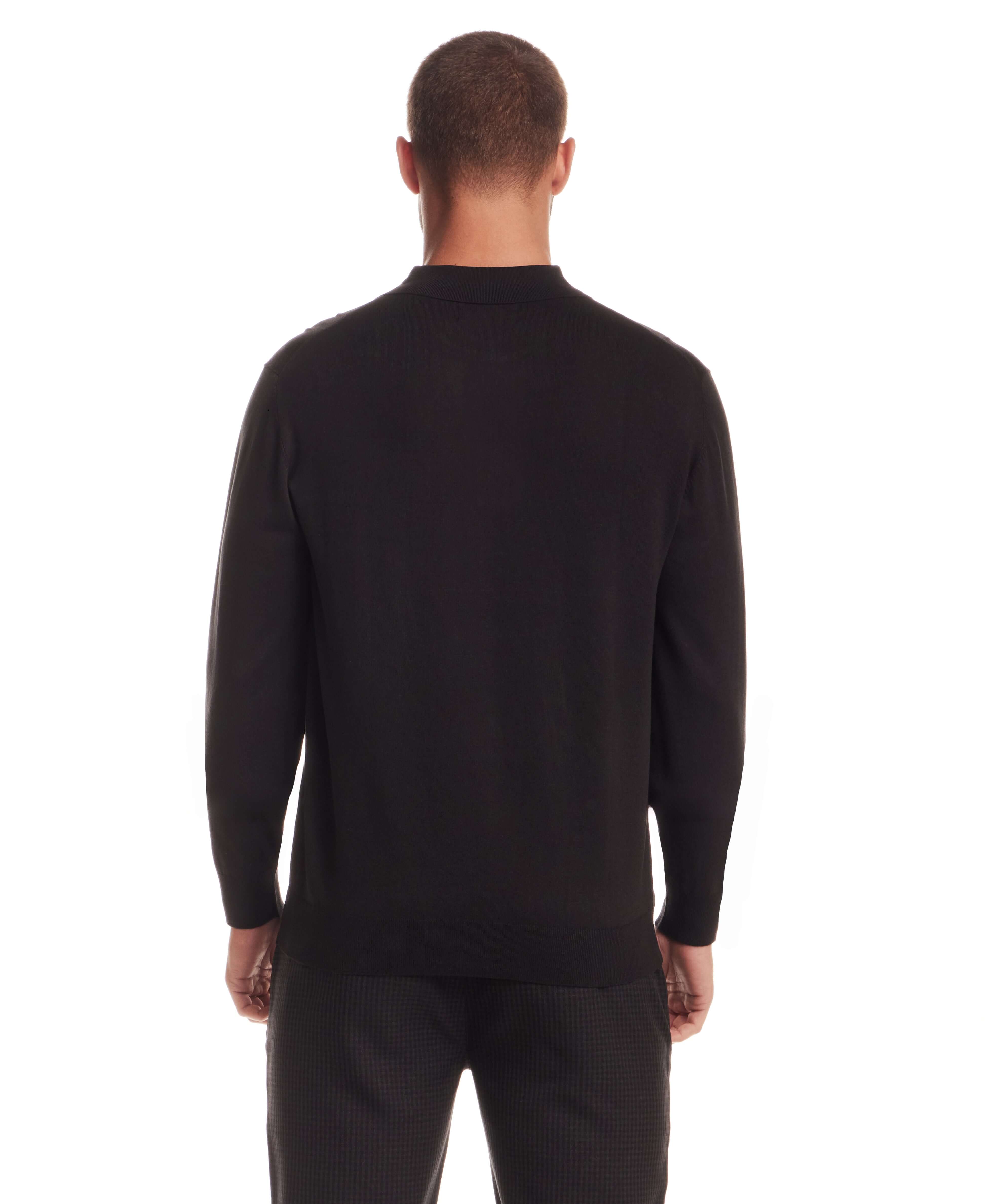Back view of a man wearing a Long Sleeve Polo Sweater in Black, highlighting its refined knit and comfortable fit.