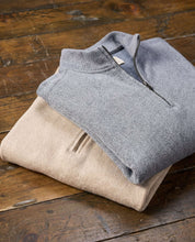 Long Sleeve Quarter Zip in Maritime Blue and beige pullover stacked on wooden table.