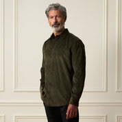 Long Sleeve Solid Cord Button Down in Olive worn by a man, showcasing its soft corduroy texture and buttoned front.