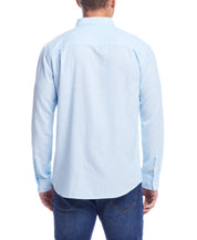 Back view of a model wearing a Long Sleeve Solid Cotton Twill Shirt In Crystal Blue, showcasing its sleek design.