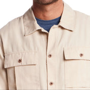 Close-up of a long sleeve unlined utility shirt jacket in white pepper with button-through pockets and a classic fit.