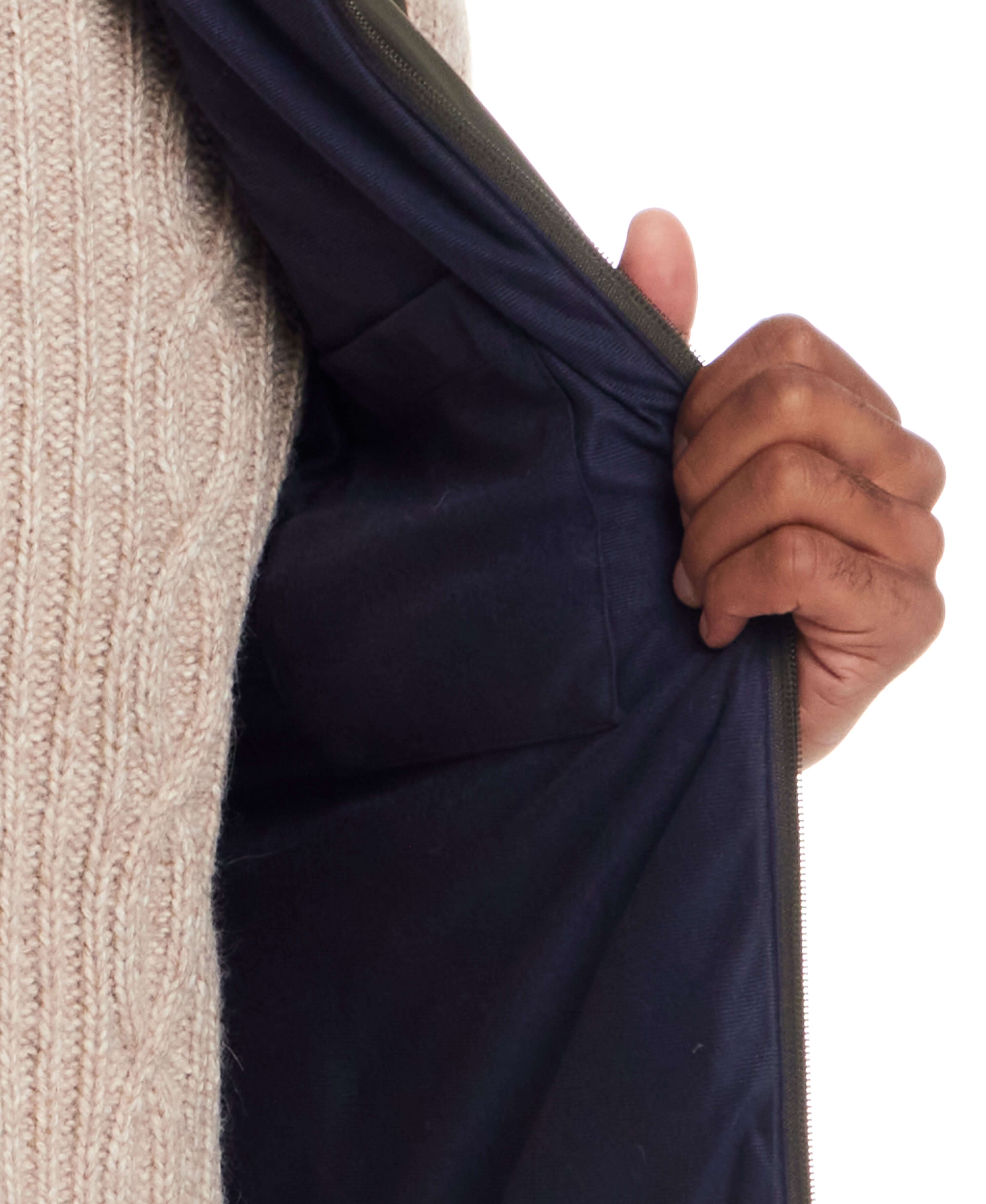 Interior view of Matte Coated Shell Puffer Vest in Kambaba Olive showcasing zip closure and pocket.