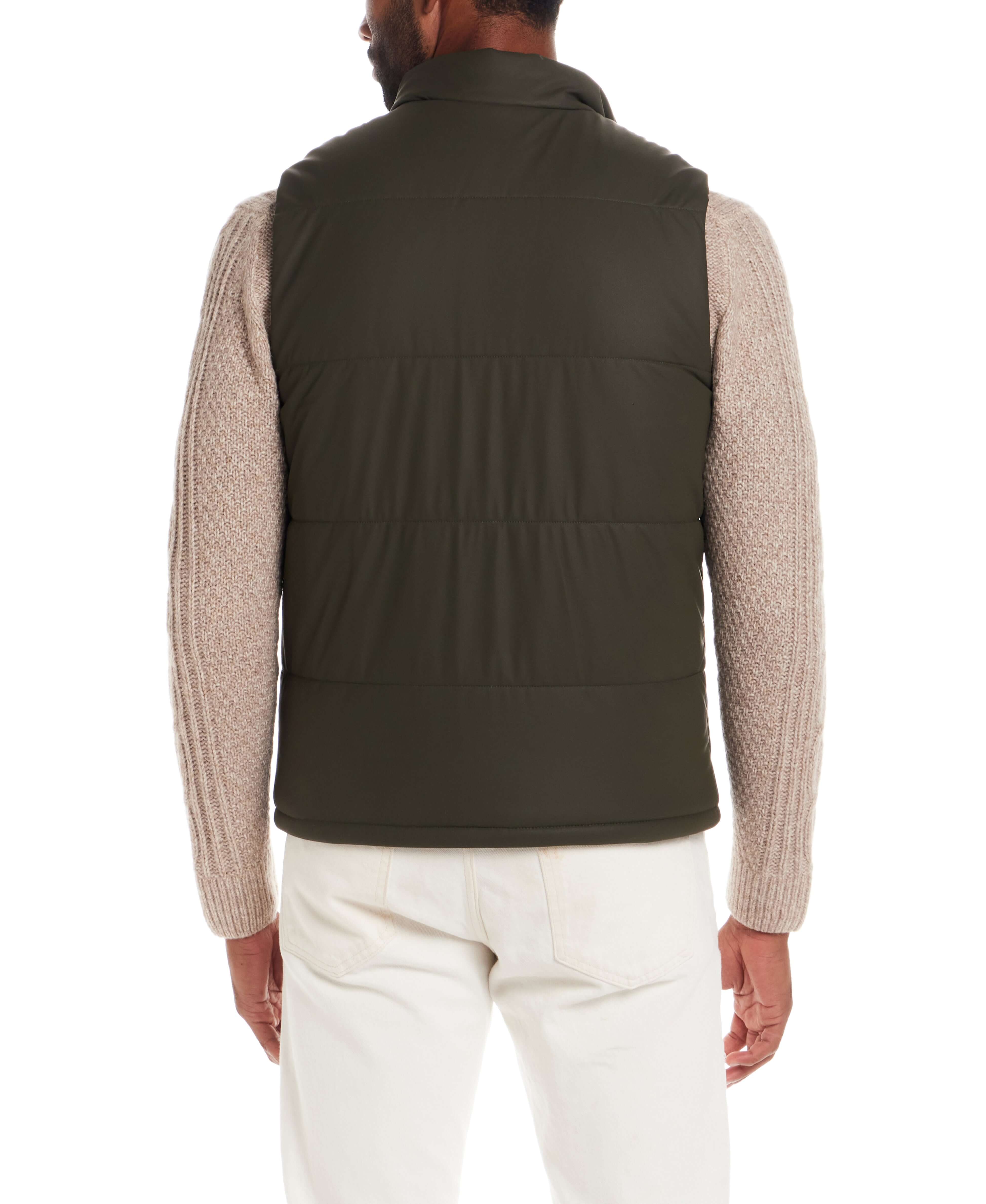 Model wearing the Matte Coated Shell Puffer Vest in Kambaba Olive from the back, showcasing its sleek design and classic fit.