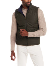 Matte Coated Shell Puffer Vest in Kambaba Olive worn over a light sweater, showcasing its modern design and utility.