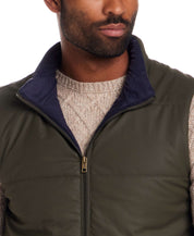 Matte Coated Shell Puffer Vest in Kambaba Olive on model, showcasing the zip-front closure and contrast collar.