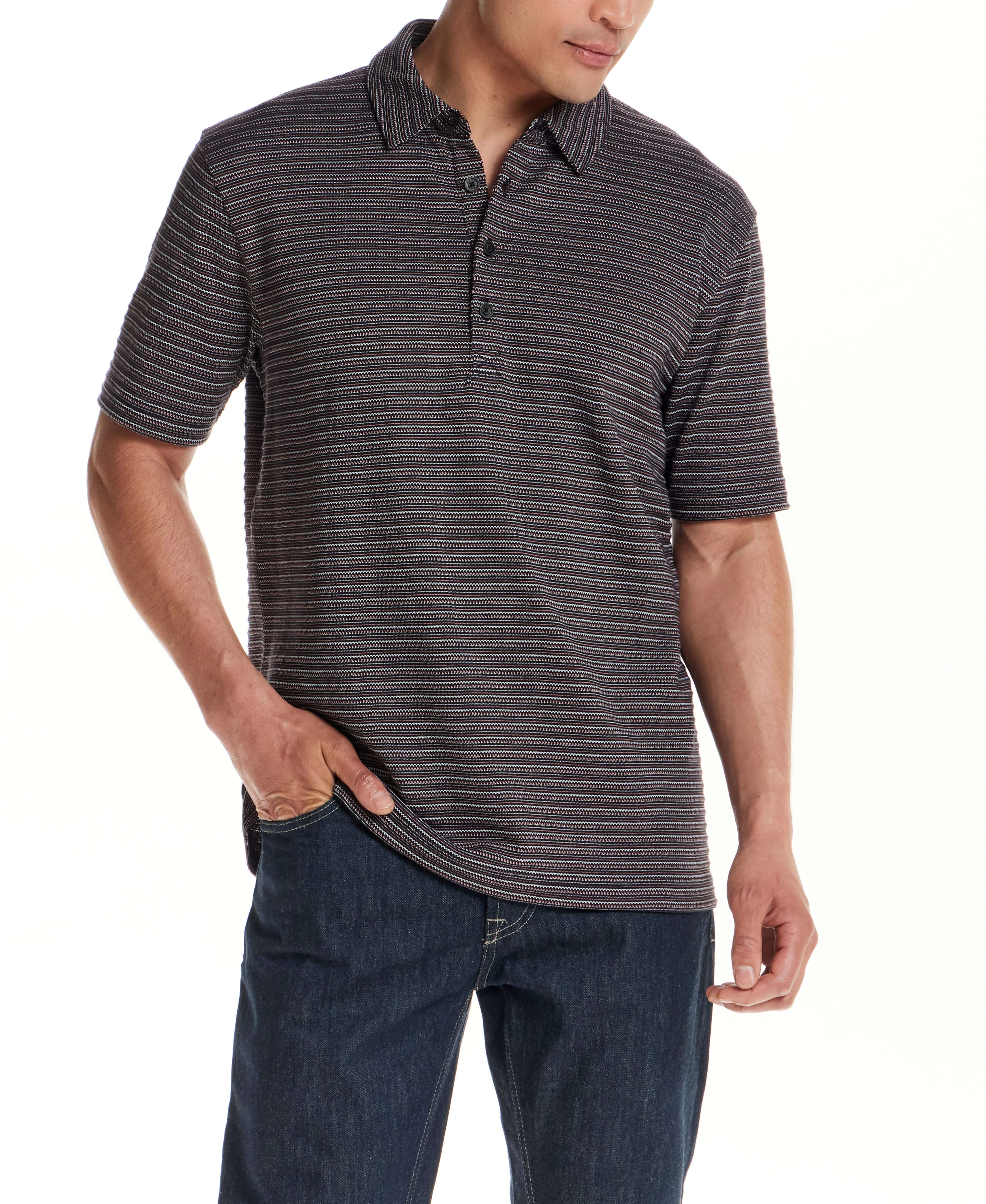 Model showcasing the Jacquard Stripe Polo in Black, featuring subtle striping and a structured fit.