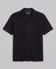 Seersucker Coatfront Knit in Black showcasing a subtle grid texture with a structured collar and button-front closure.