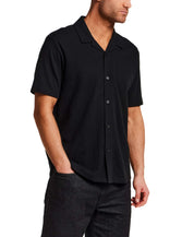 Model wearing a Seersucker Coatfront Knit in Black shirt with structured collar and button-front closure.