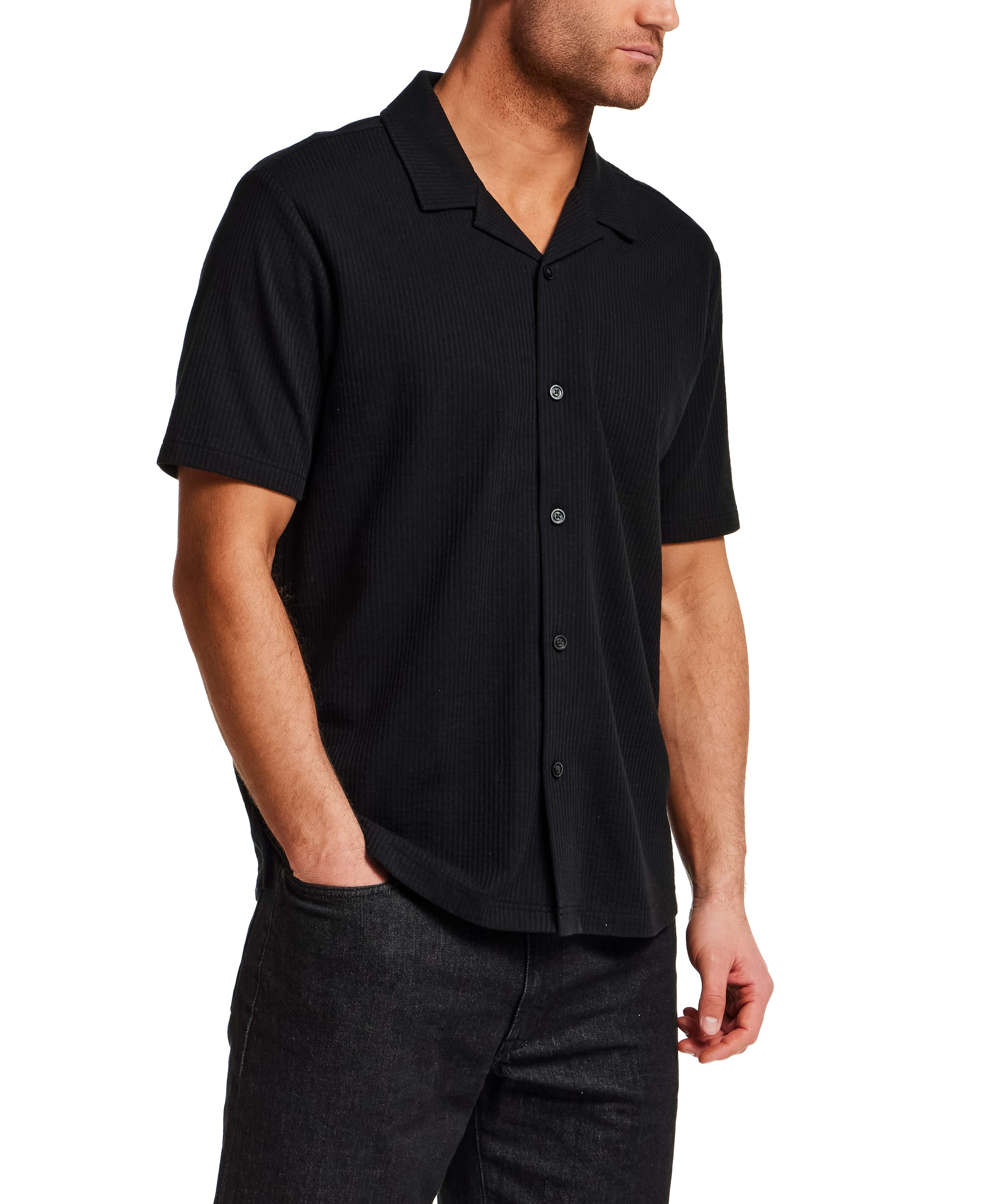 Model wearing a Seersucker Coatfront Knit in Black shirt with structured collar and button-front closure.