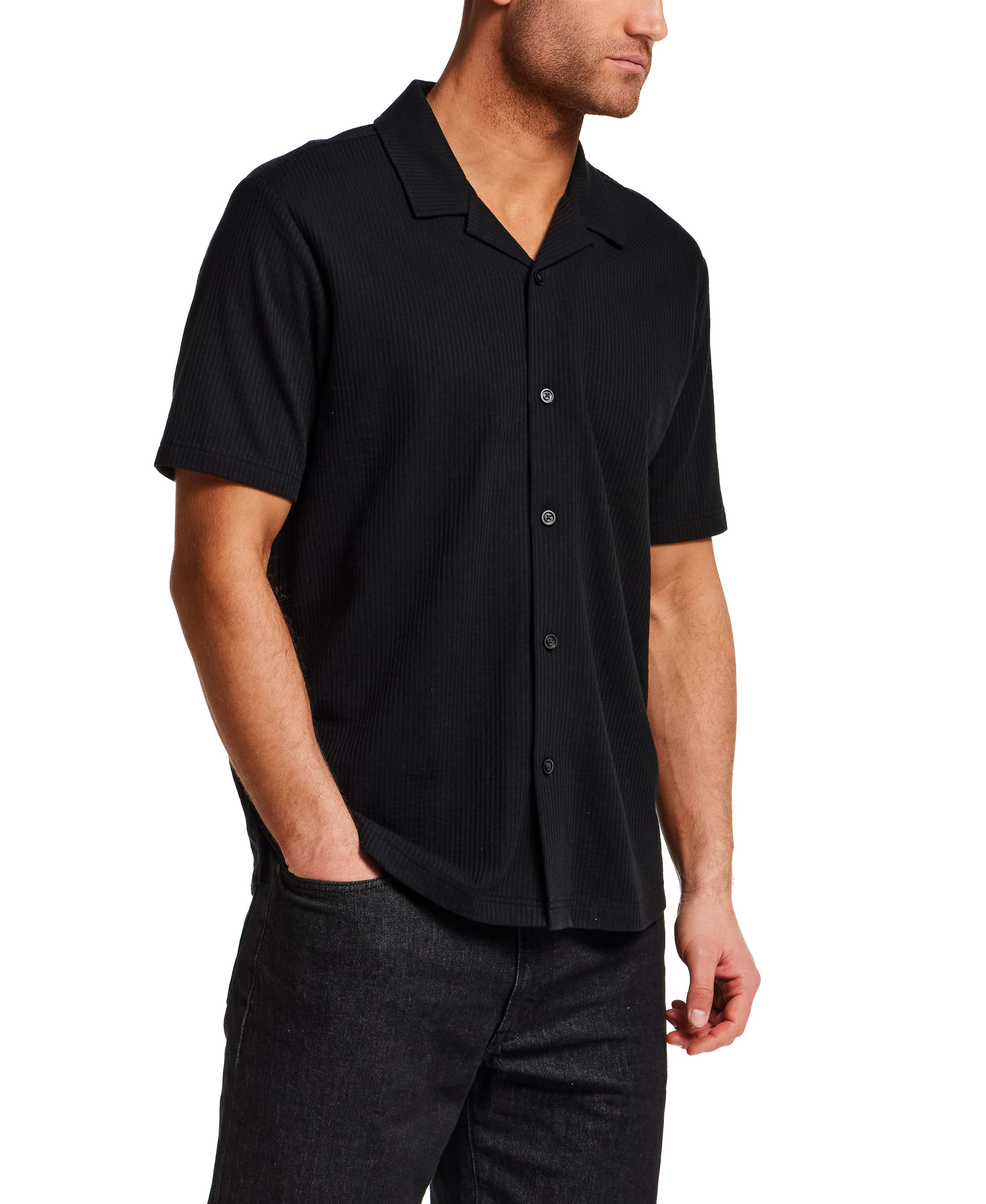 Model wearing a Seersucker Coatfront Knit in Black shirt with structured collar and button-front closure.