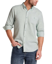 Model wearing Pebble Dobby Button-Down Shirt in Sea Grass, showcasing its button-down collar and chest pocket.