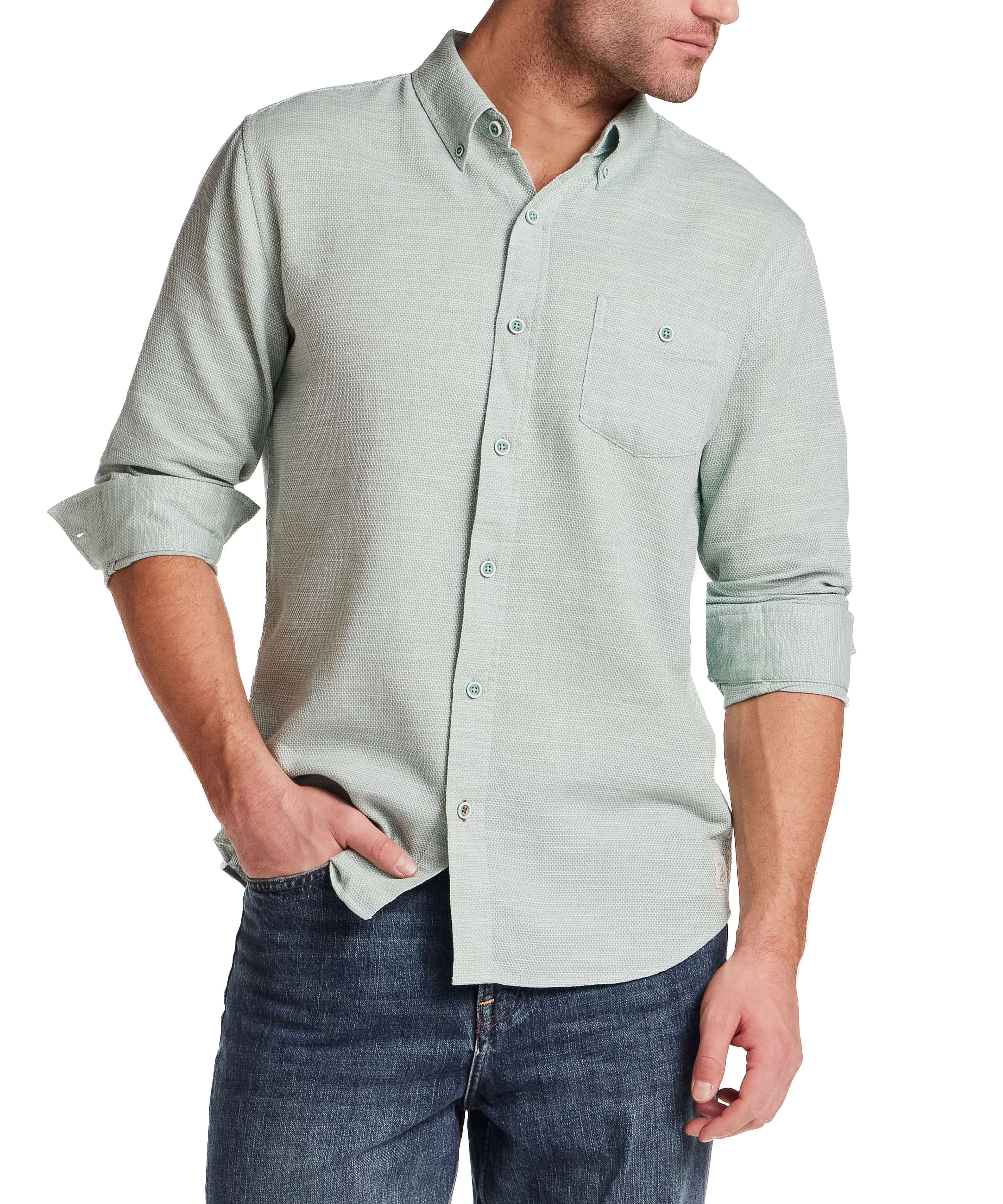 Model wearing Pebble Dobby Button-Down Shirt in Sea Grass, showcasing its button-down collar and chest pocket.