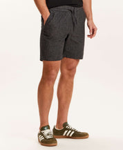 Chambray Stripe Drawstring Short in Black worn by a model, featuring an elastic waistband and side pockets.