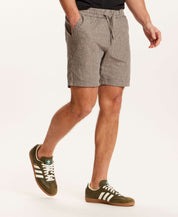 Chambray Stripe Drawstring Short in Black Stripe worn by a model with side pockets and elastic waistband, creating a casual summer look.