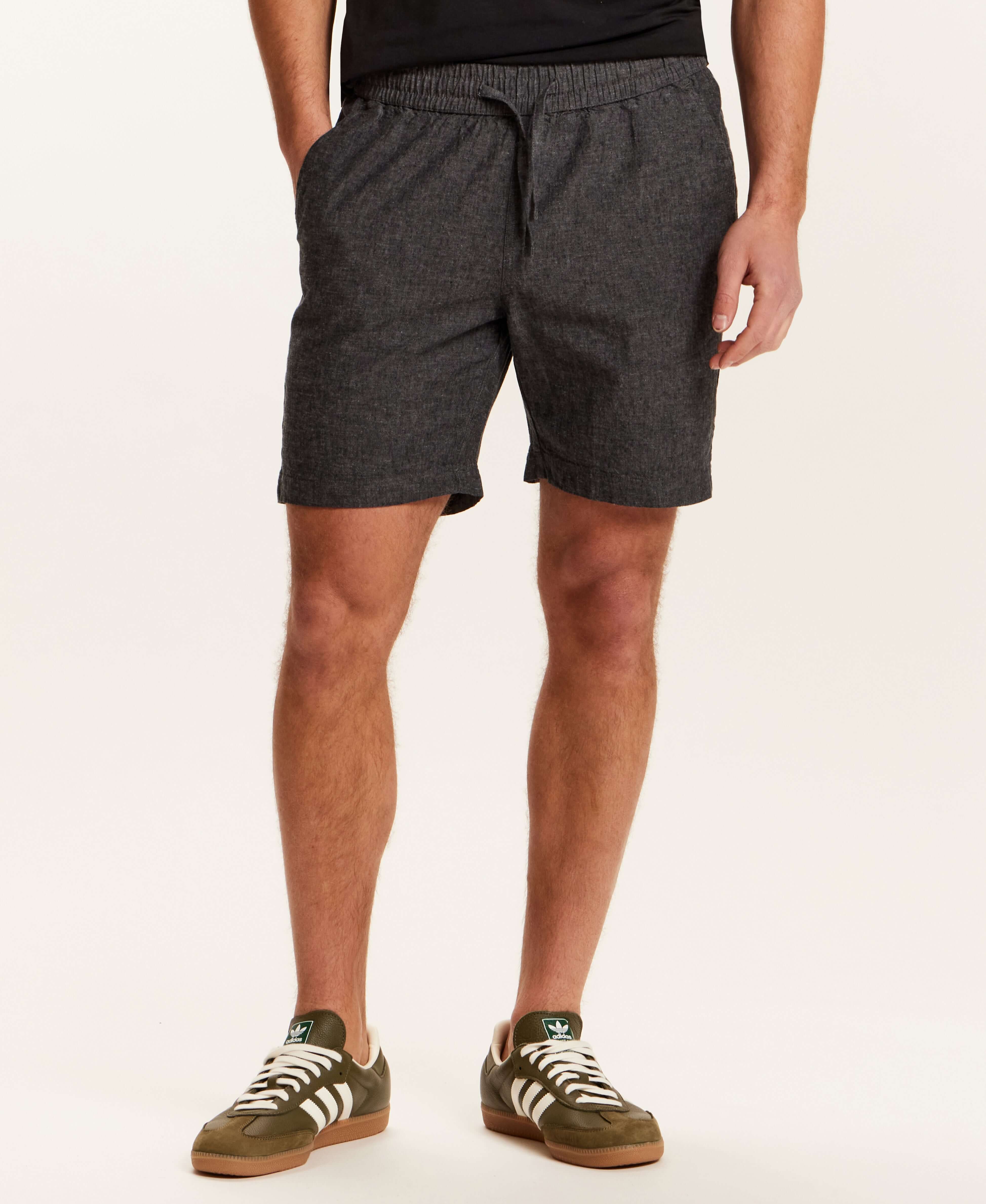 Chambray Stripe Drawstring Short in Black showcased on a model, featuring an elastic waistband and side pockets.
