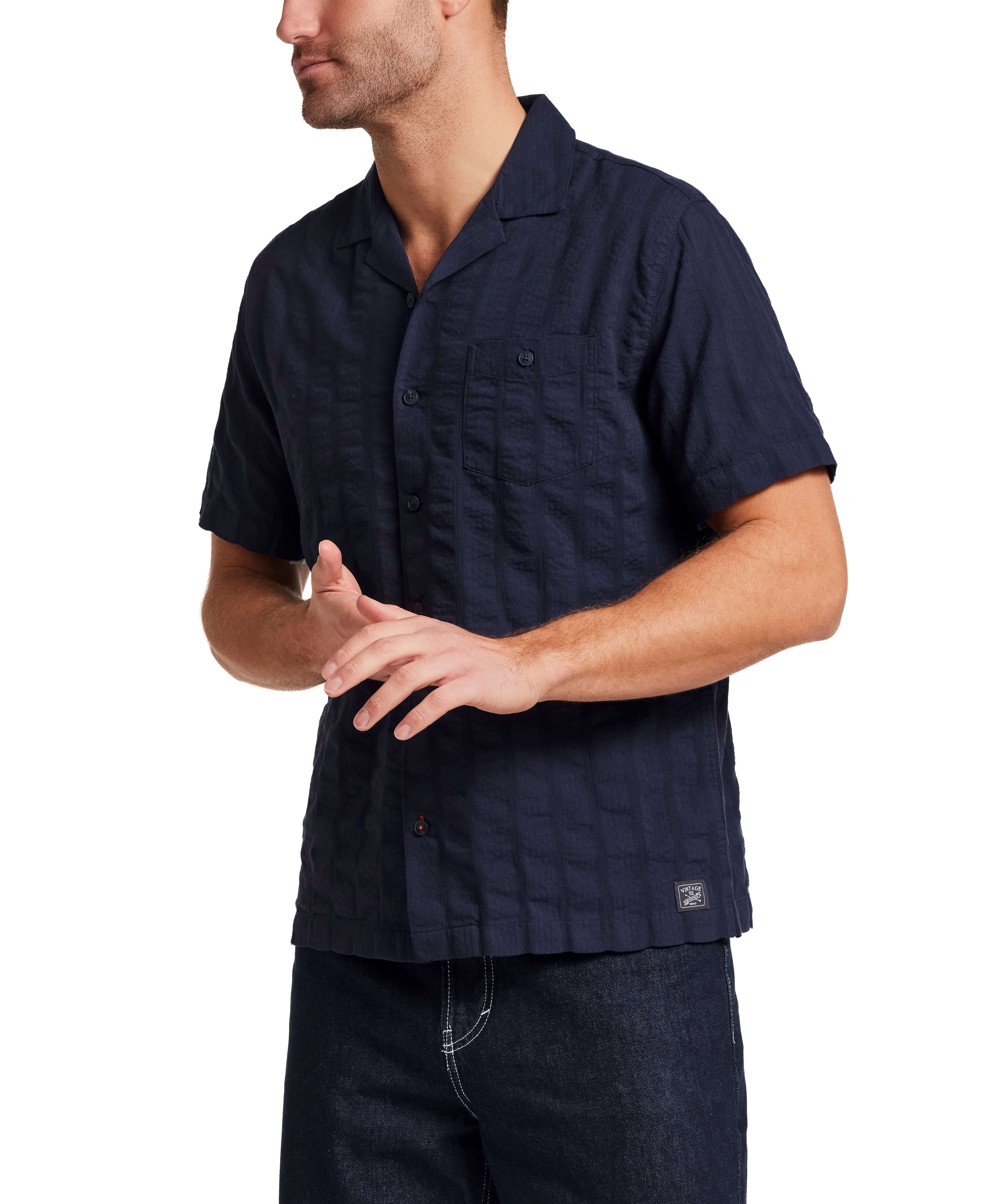 Cotton Dobby Seersucker Shirt in Maritime Blue worn by a model with short sleeves and chest pocket, ideal for warm weather.