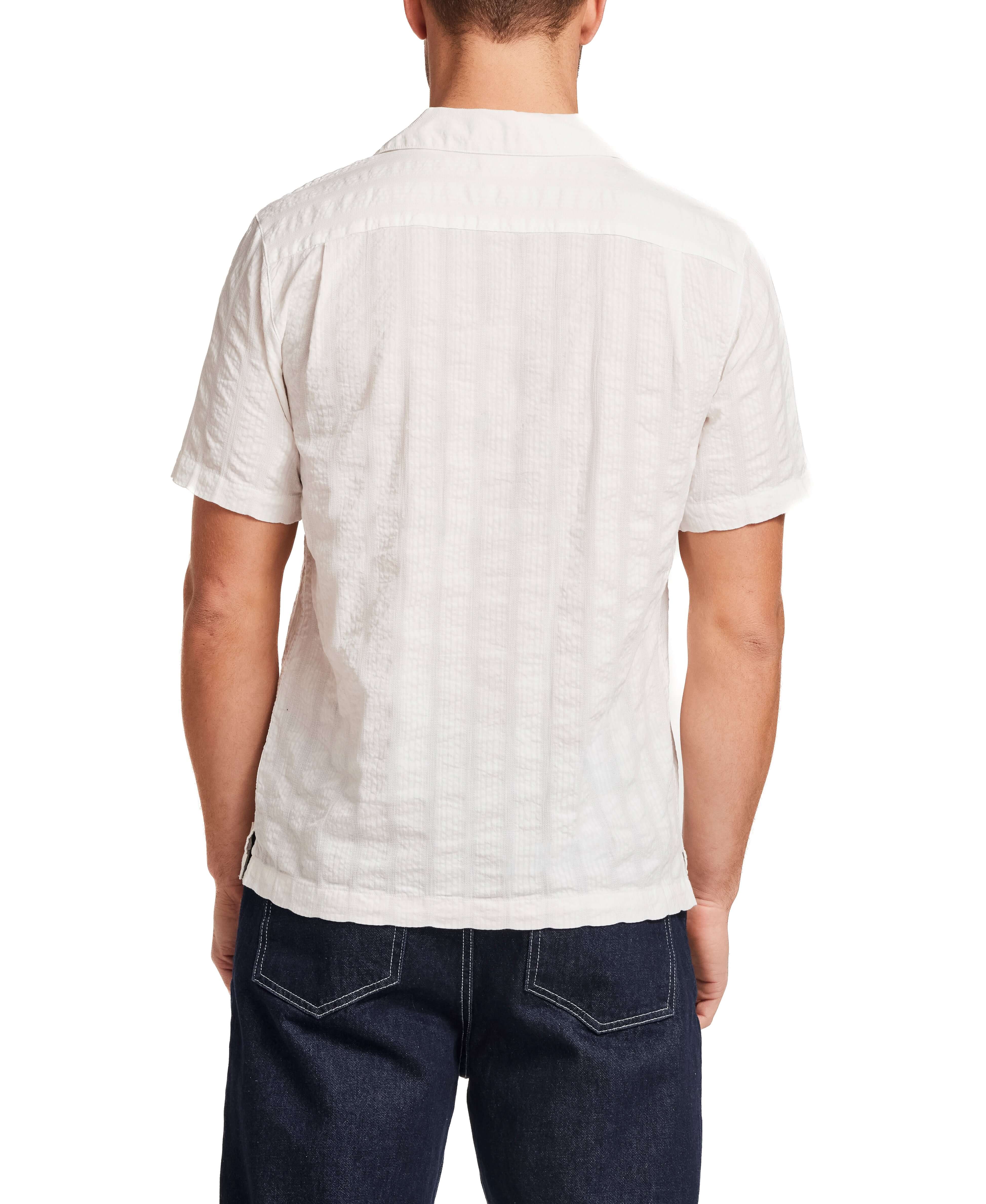 Back view of a man wearing a Cotton Dobby Seersucker Shirt in White, showcasing its lightweight and breathable design.