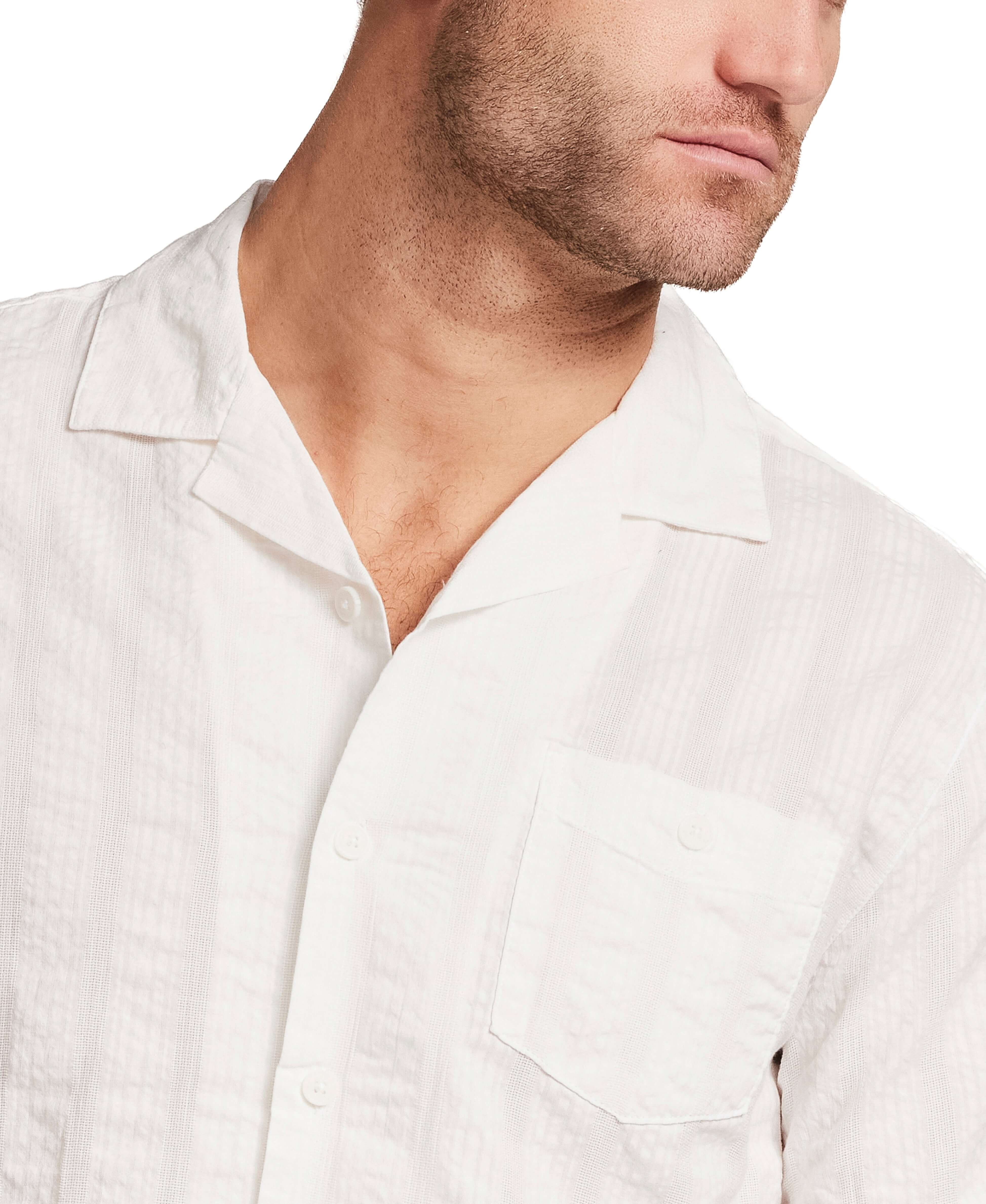 Cotton Dobby Seersucker Shirt in White displayed on a model, showcasing its camp collar and chest pocket.