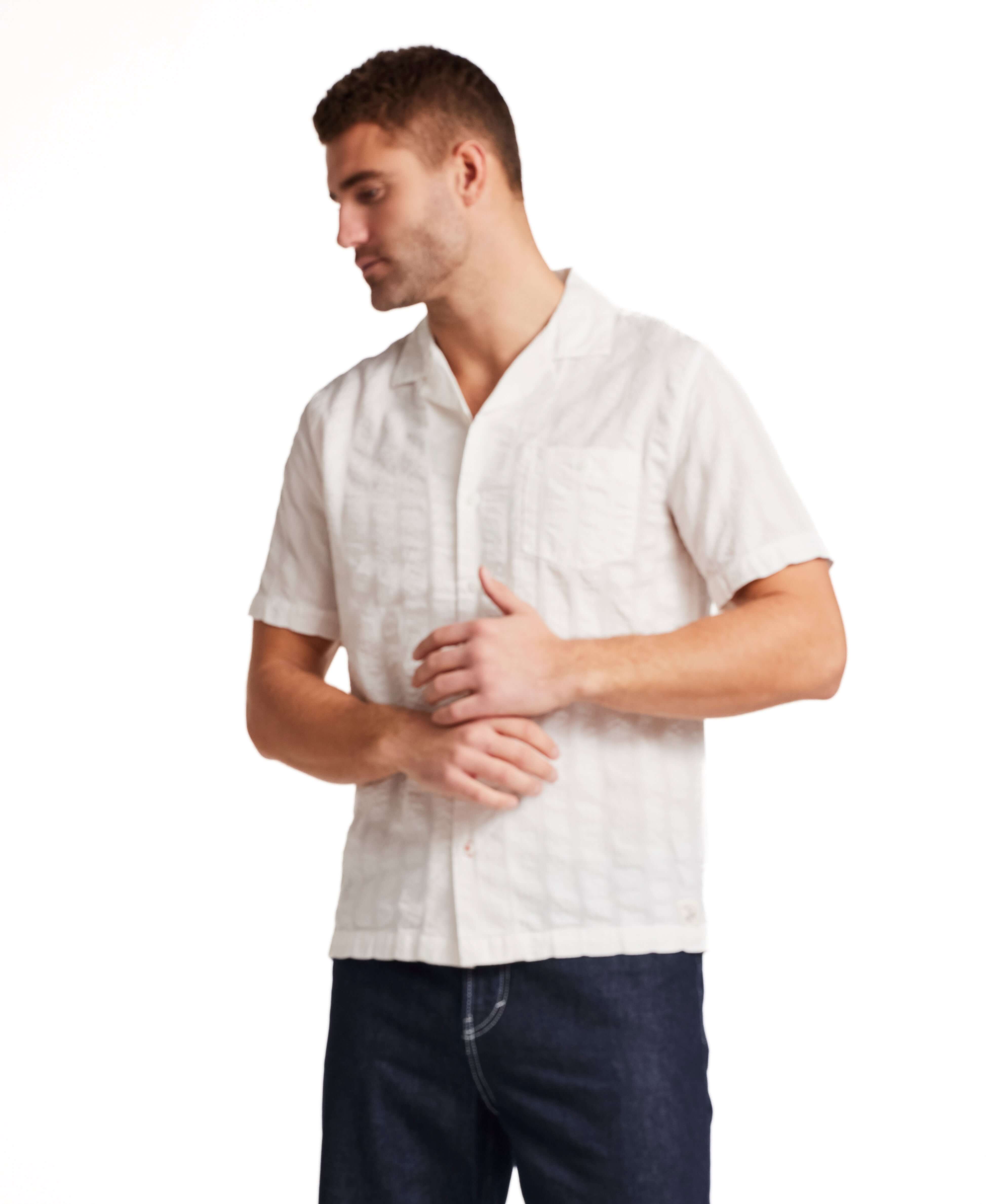 Model wearing a Cotton Dobby Seersucker Shirt in White, showcasing a relaxed fit and camp collar design.