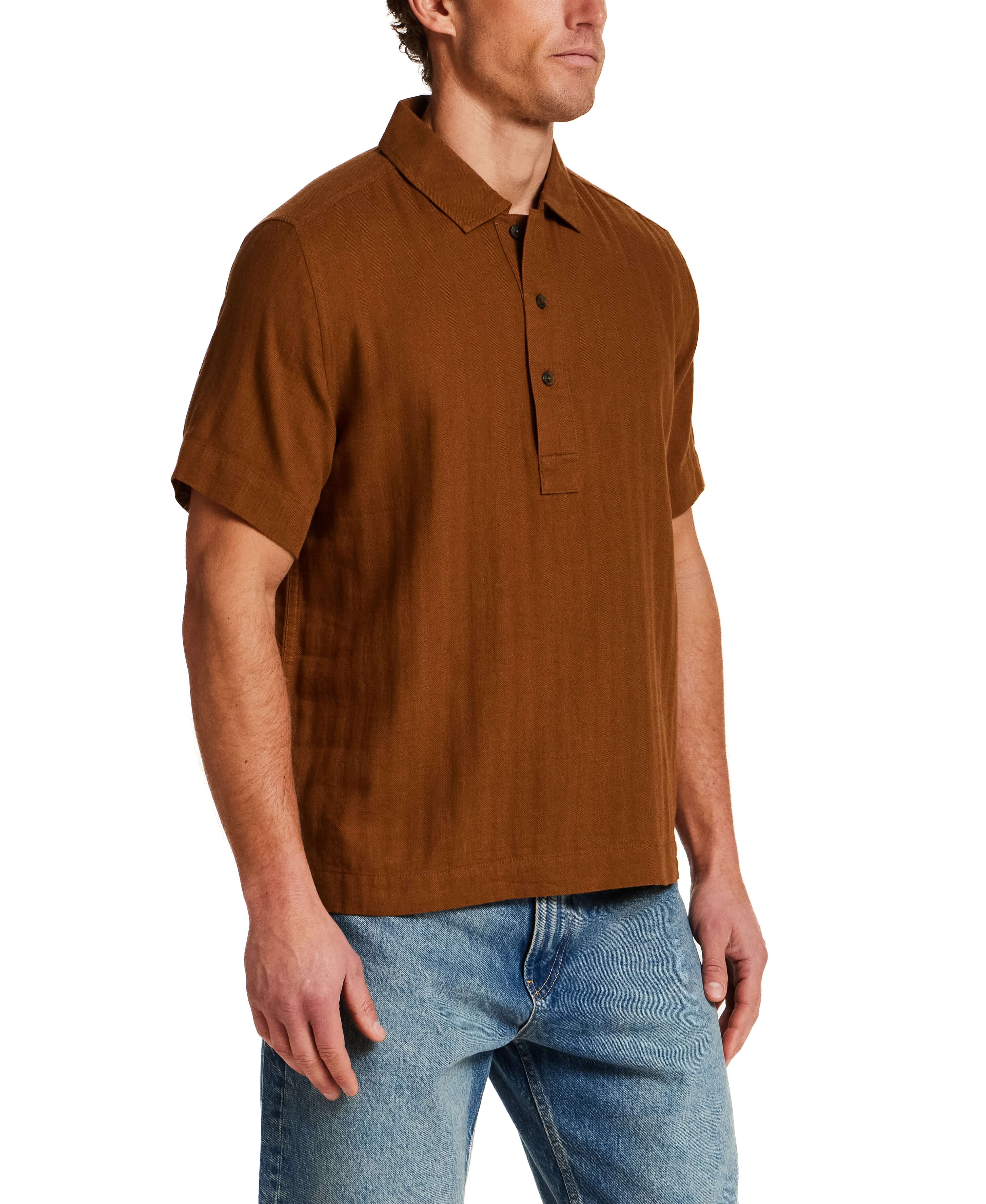 Cotton Gauze Herringbone Polo in Retro Brown worn by model, showcasing short sleeves and textured fabric.
