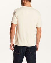 Back view of a man wearing the Horizontal Rib Tee in Cream with short sleeves and a crew neckline.