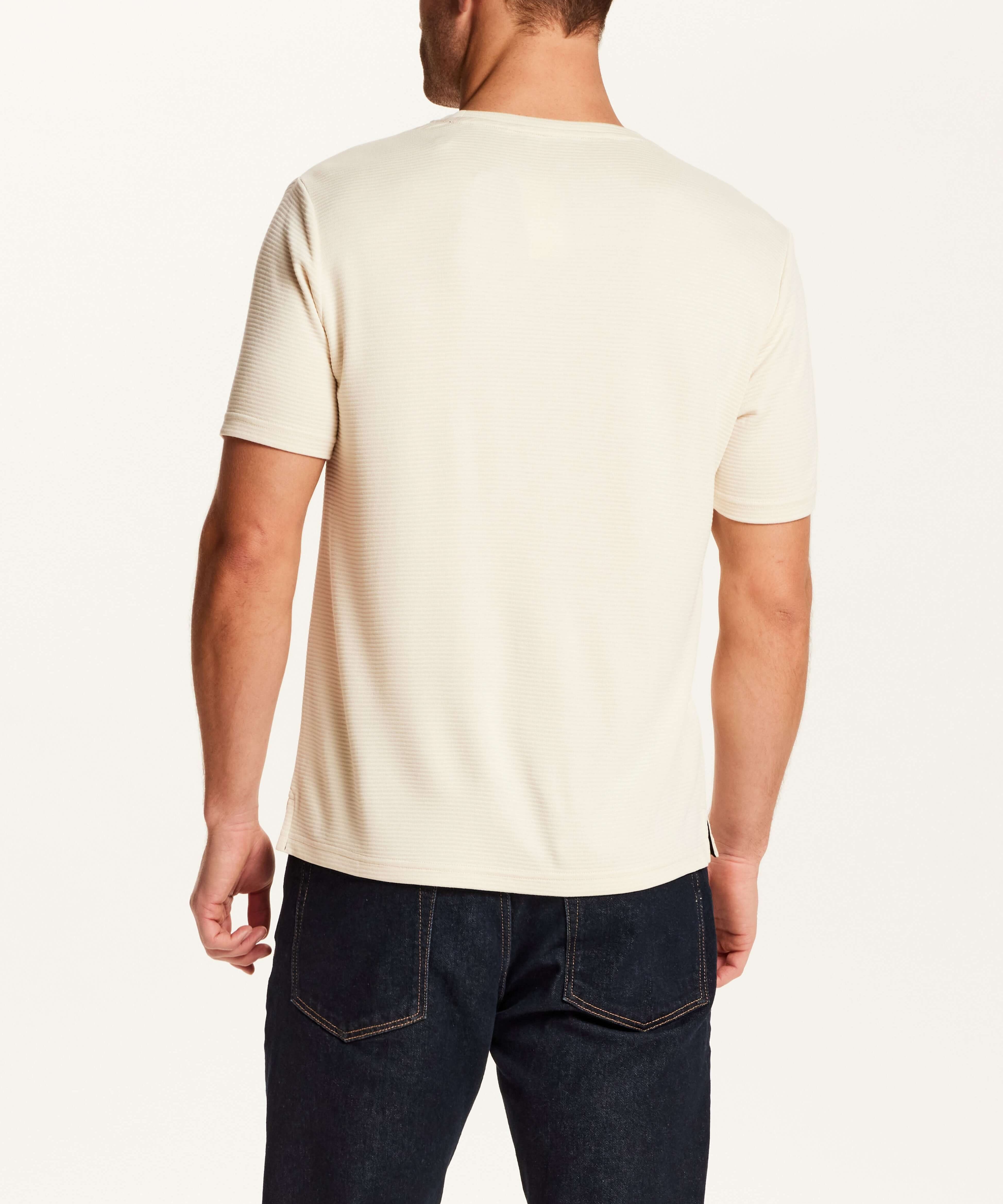 Back view of a man wearing the Horizontal Rib Tee in Cream with short sleeves and a crew neckline.