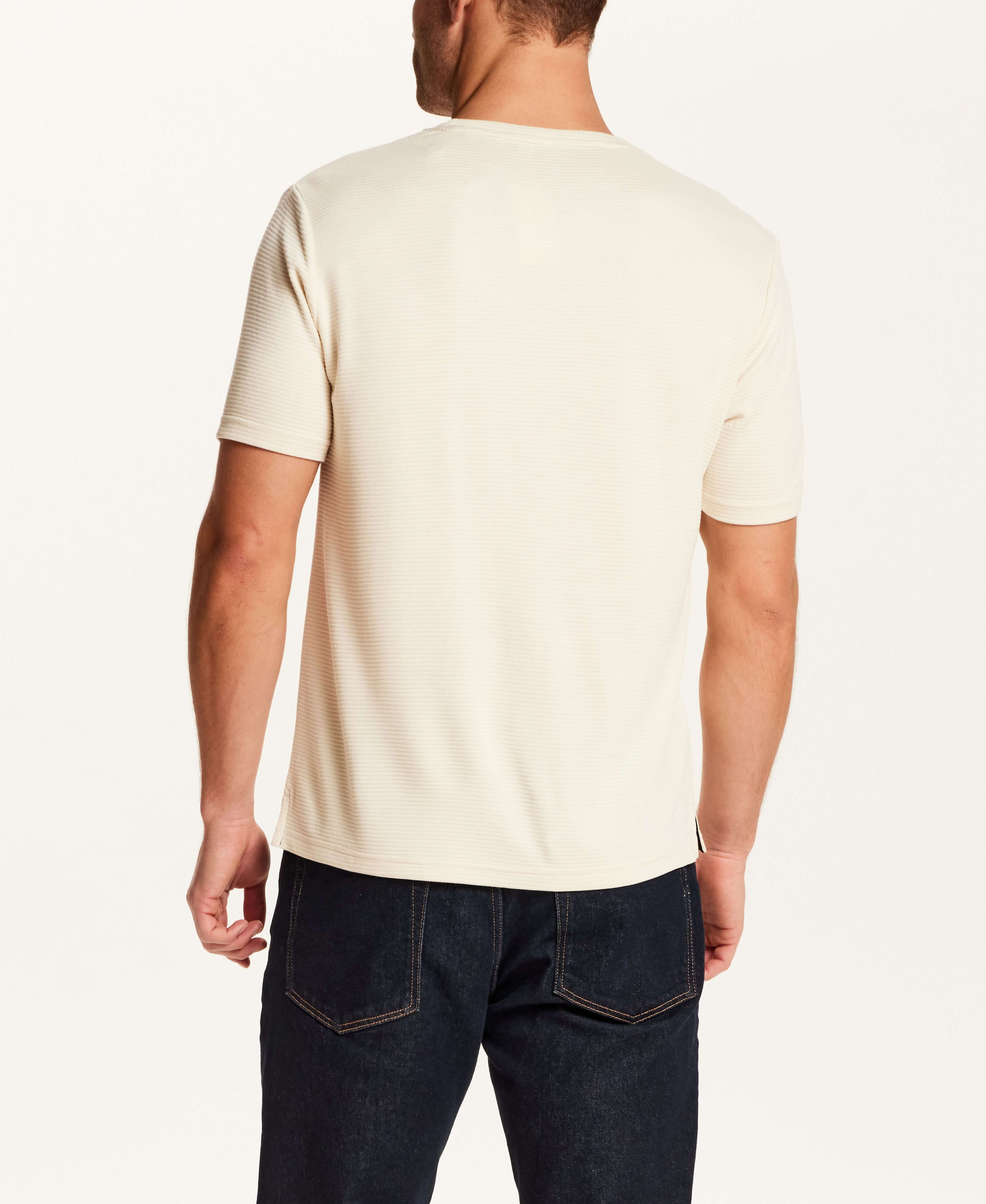 Back view of a man wearing the Horizontal Rib Tee in Cream with short sleeves and a crew neckline.