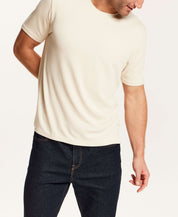 Horizontal Rib Tee in Cream worn by a model, featuring a soft modal blend and crew neckline.